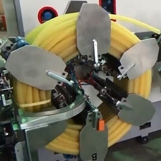 Pipe coiling and strapping machine