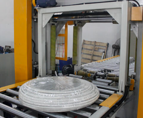 Reel wrapping machine for packaging steel coils, bearing and reels